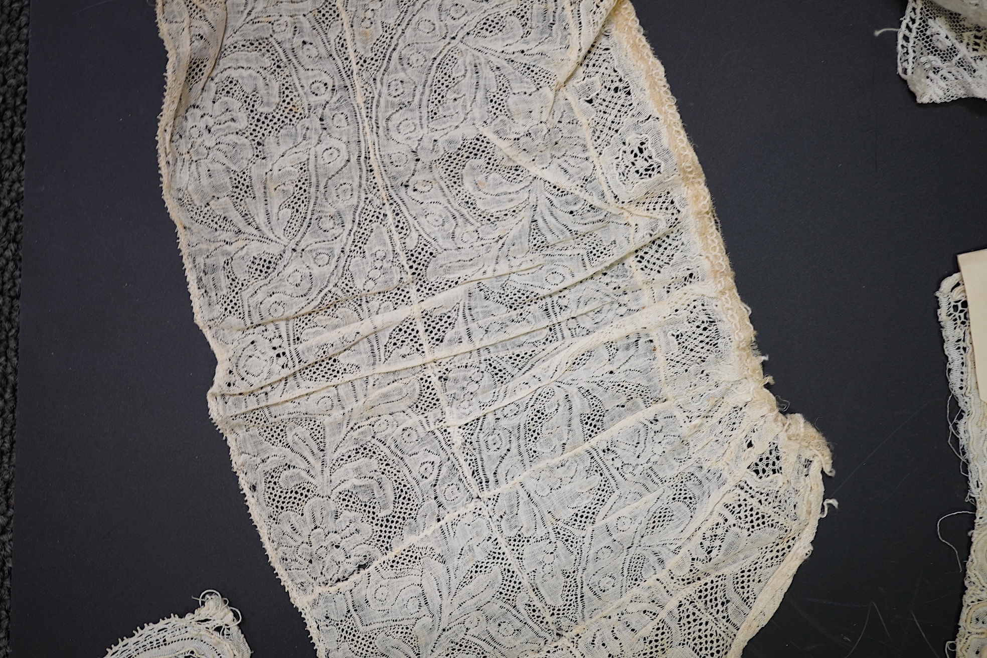 Various lengths of 18th and 19th century lace trimming and two needle run bonnets. Including a collar made from two rows of 18th century Valenciennes lace, a length Valenciennes lace, a shorter length of Pointe de Anglet
